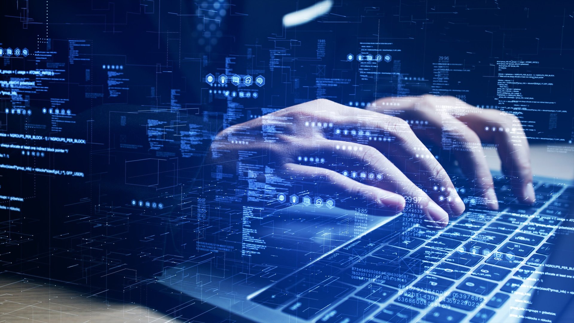 Programmer typing on laptop with digital interface